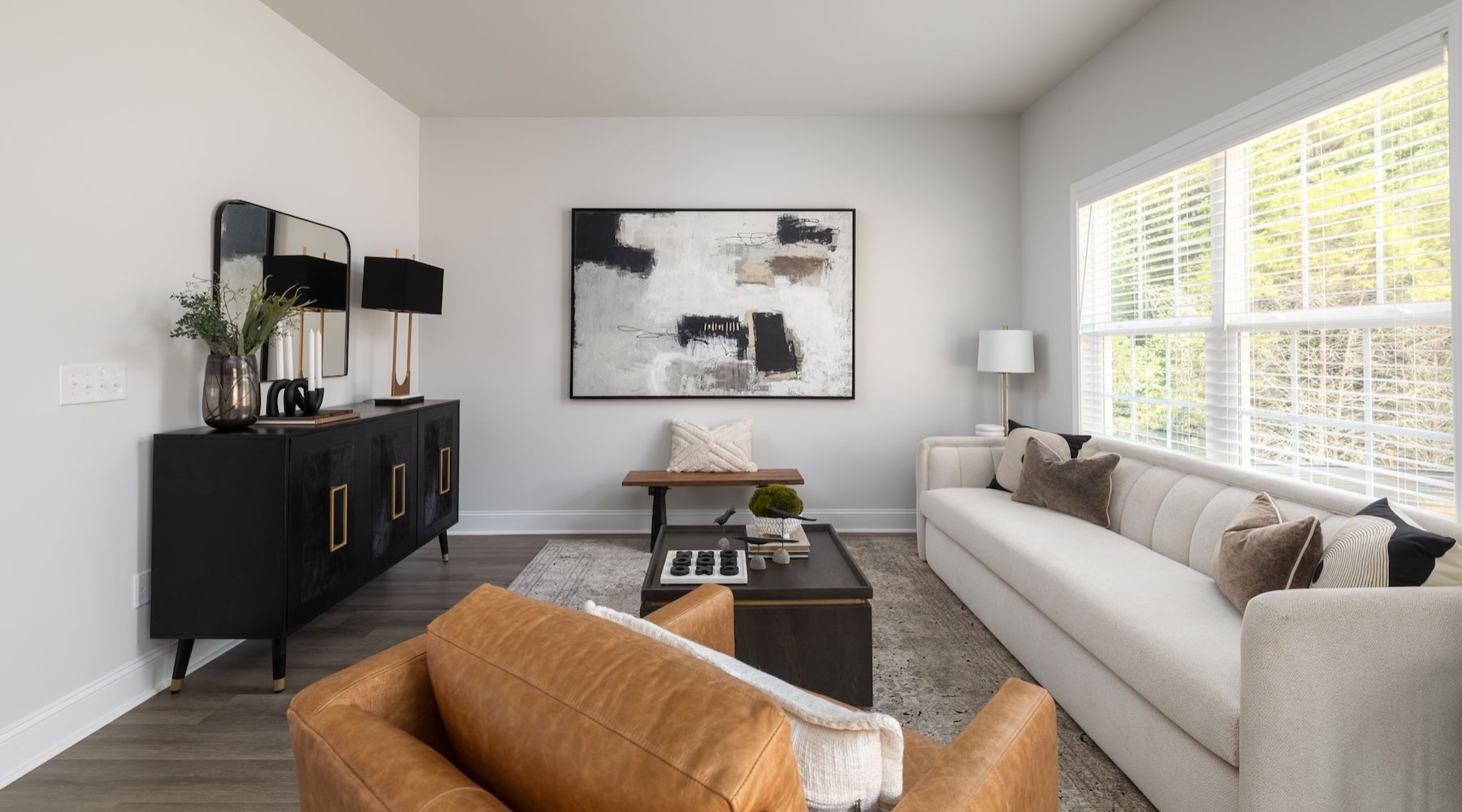 a living room with a couch, tables and chairs